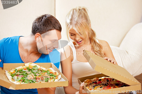 Image of romantic couple eating pizza at home