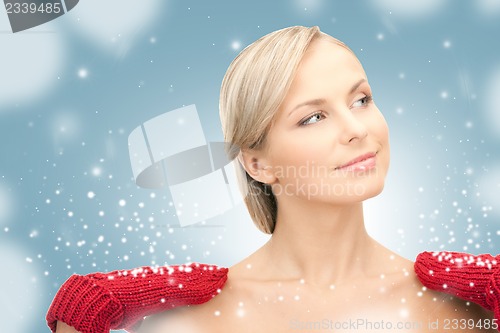 Image of beautiful woman in red mittens