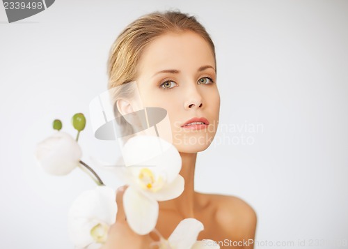 Image of lovely woman with orchid flower
