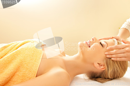 Image of beautiful woman in massage salon