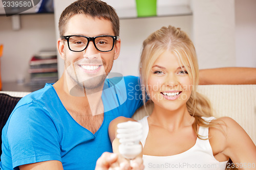 Image of couple holding energy saving bulb