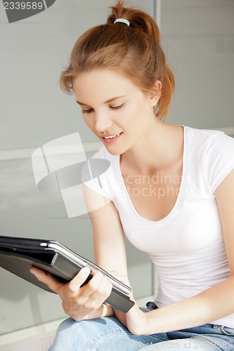 Image of happy teenage girl with tablet pc computer