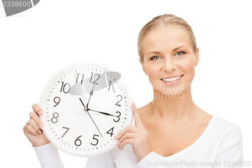 Image of woman holding big clock