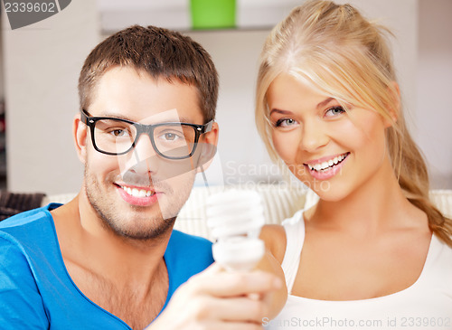 Image of couple holding energy saving bulb