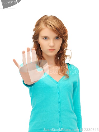 Image of young woman making stop gesture