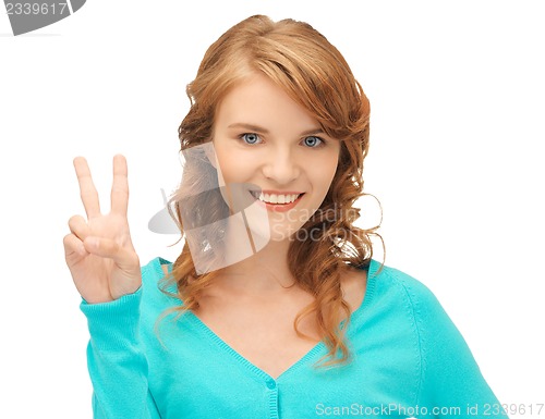 Image of teenage girl showing victory sign