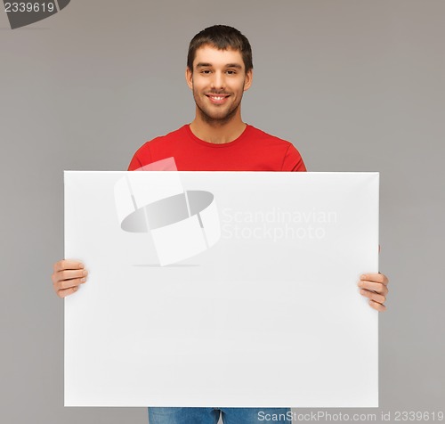 Image of handsome man with big blank board