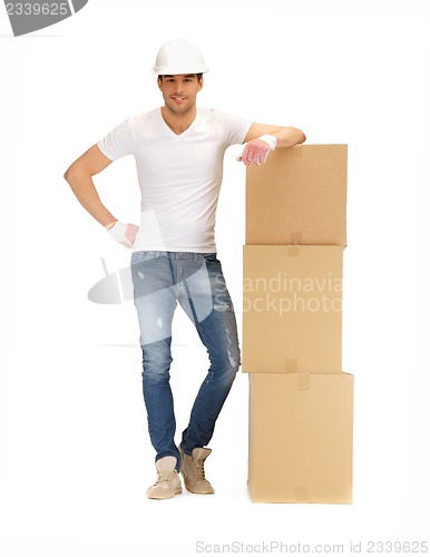 Image of handsome builder with big boxes