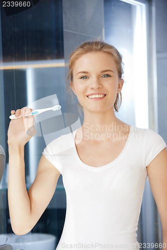 Image of smiling teenage girl with toothbrush