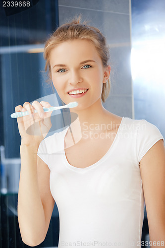 Image of smiling teenage girl with toothbrush