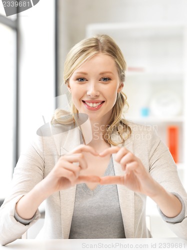 Image of young woman showing heart sign