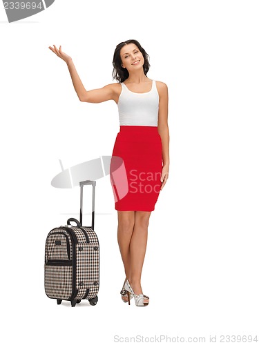 Image of happy woman with suitcase greeting