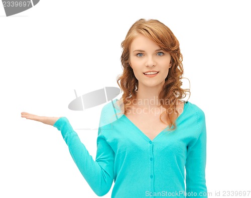 Image of girl showing something on the palm of her hand