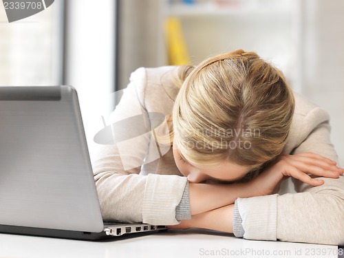 Image of tired woman with laptop computer
