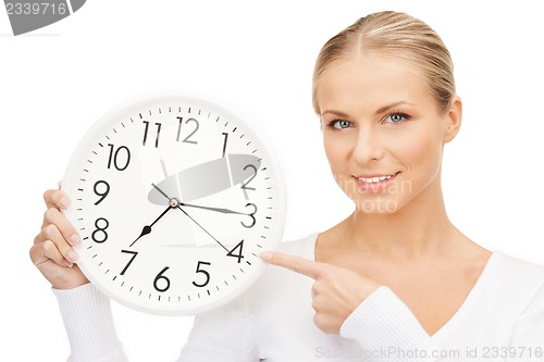 Image of woman holding big clock