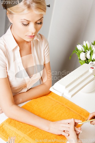 Image of woman having a manicure at the salon