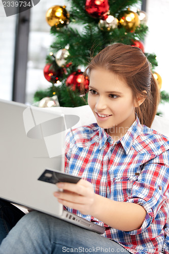 Image of woman with laptop computer and credit card