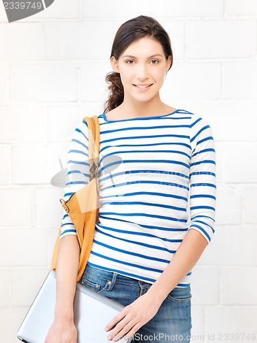 Image of happy and smiling teenage girl with laptop