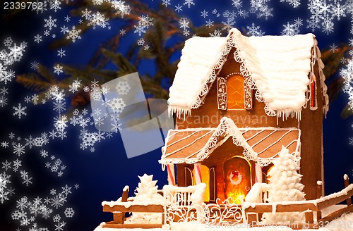 Image of gingerbread house over christmas background