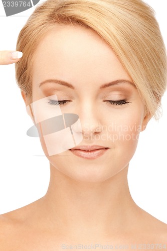 Image of beautiful woman pointing to forehead