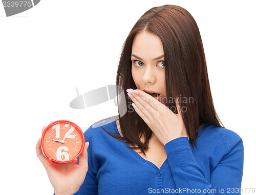 Image of woman holding alarm clock