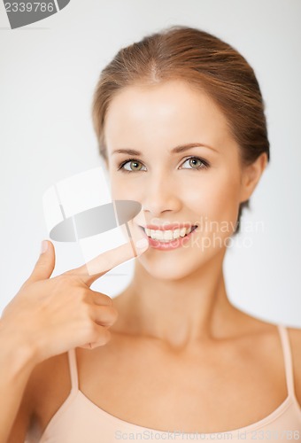 Image of beautiful woman pointing to teeth