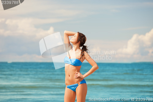 Image of happy smiling woman on the beach