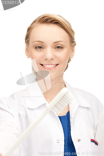 Image of attractive female doctor with toothbrush