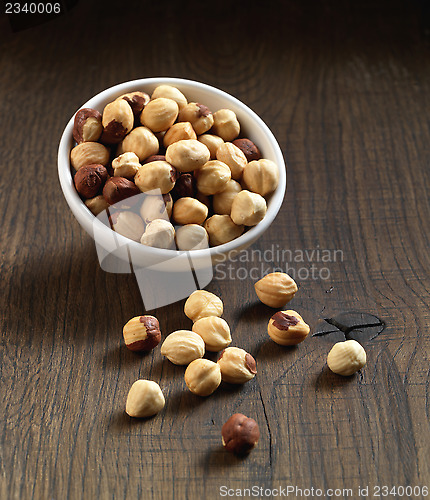 Image of Hazelnuts on brown wooden table