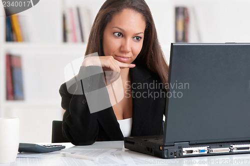 Image of Businesswoman At Office Desk