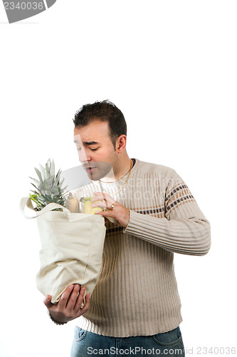 Image of Man Looking Inside His Grocery Bag