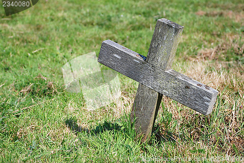 Image of Small wooden cross in a graveyard