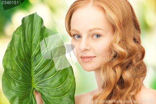 Image of woman with green leaf