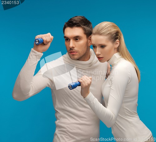 Image of man and woman with pocket flashlights