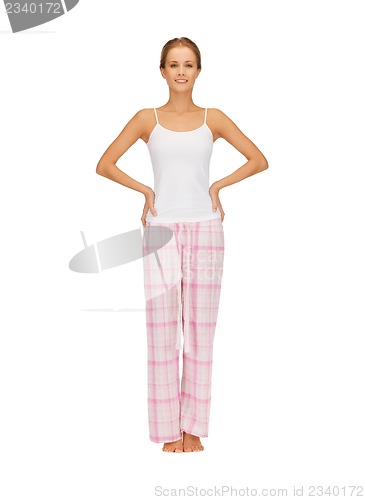 Image of happy and smiling woman in cotton pajamas