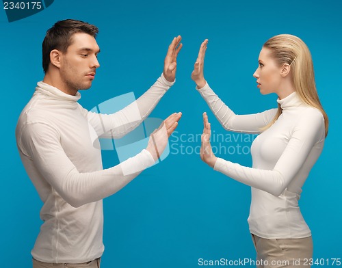 Image of man and woman working with something imaginary