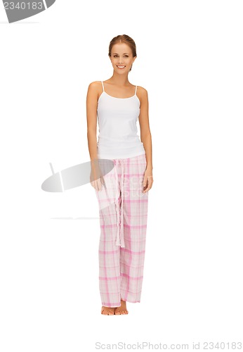 Image of happy and smiling woman in cotton pajamas