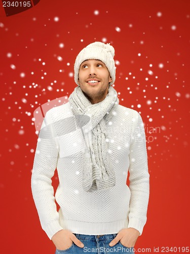 Image of handsome man in warm sweater, hat and scarf