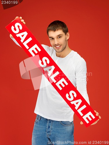 Image of handsome man with sale sign