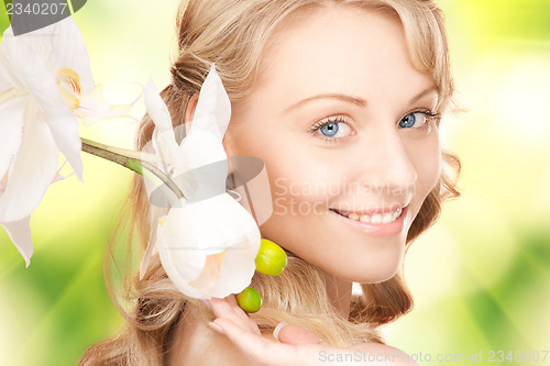 Image of beautiful woman with orchid flower