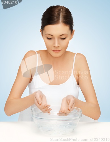 Image of woman washing her face