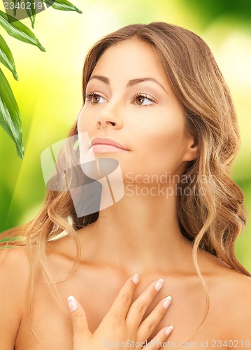 Image of beautiful woman with green leaves