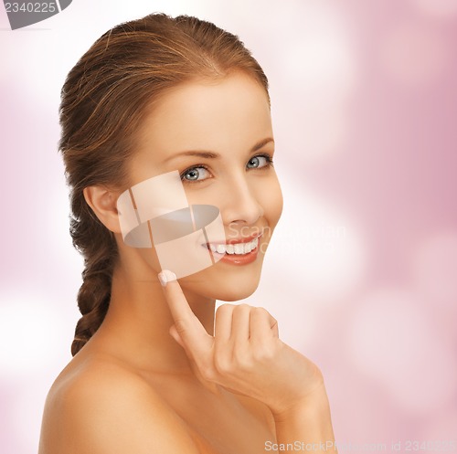 Image of beautiful woman with moisturizing creme drop