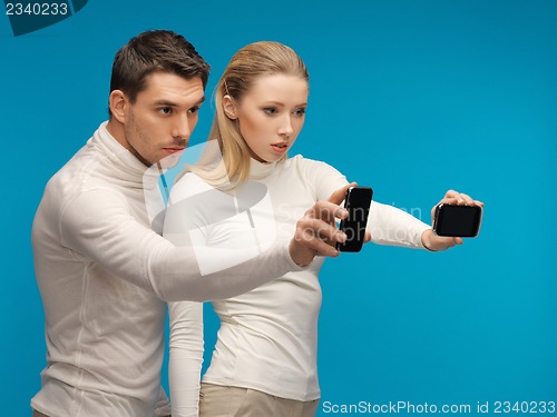 Image of man and woman with modern gadgets