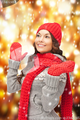 Image of beautiful woman in hat, muffler and mittens