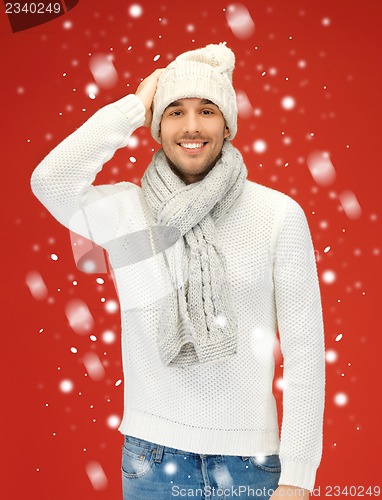 Image of handsome man in warm sweater, hat and scarf