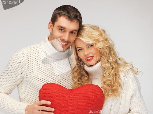 Image of family couple in a sweaters with heart