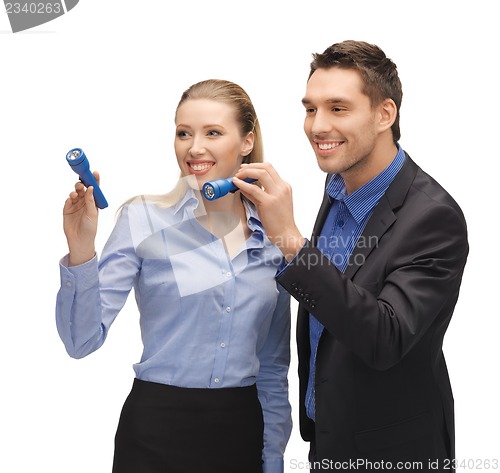 Image of man and woman with flashlights