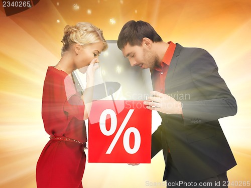 Image of man and woman with percent sign