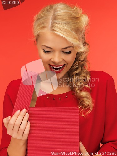 Image of lovely woman in red dress with opened gift box